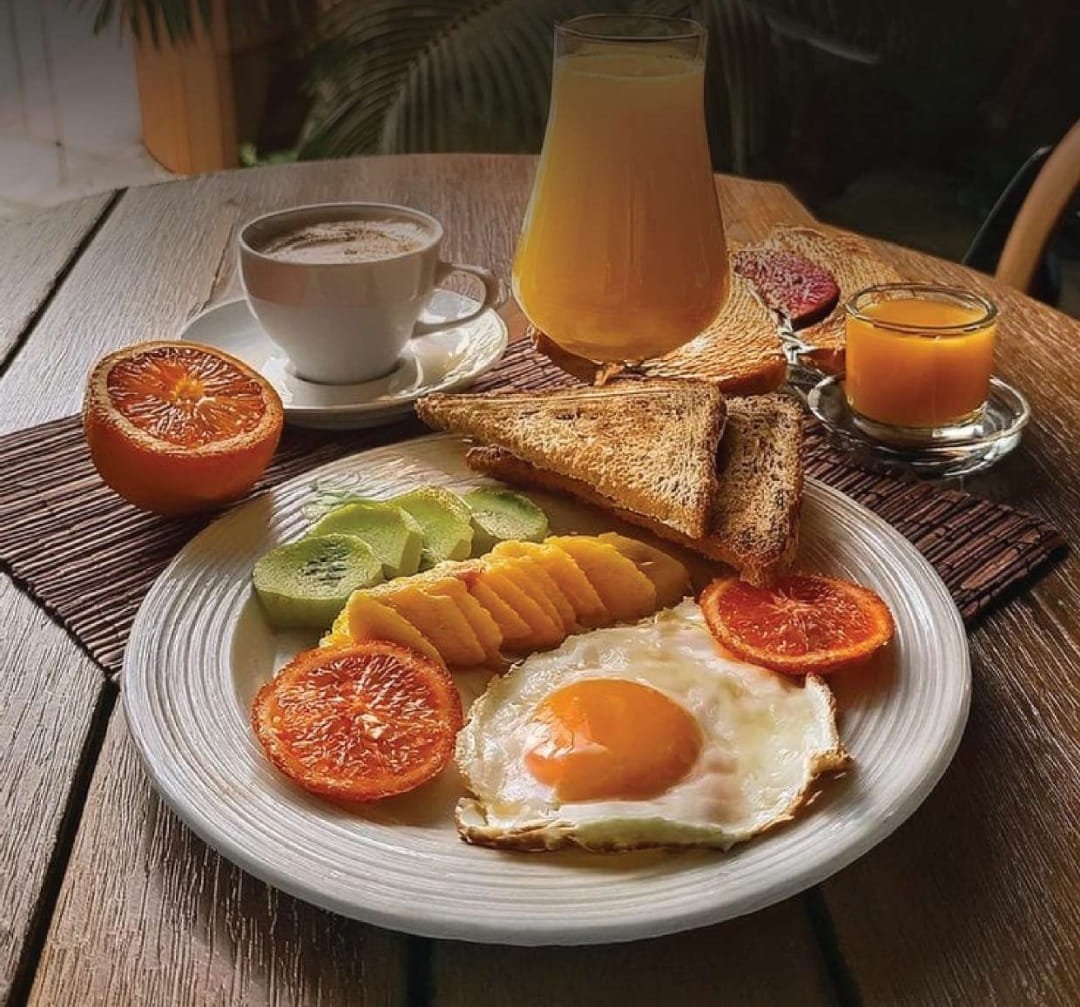 Breakfast plate with eggs, toast and juice at Gul Café, Dubai Investment Park